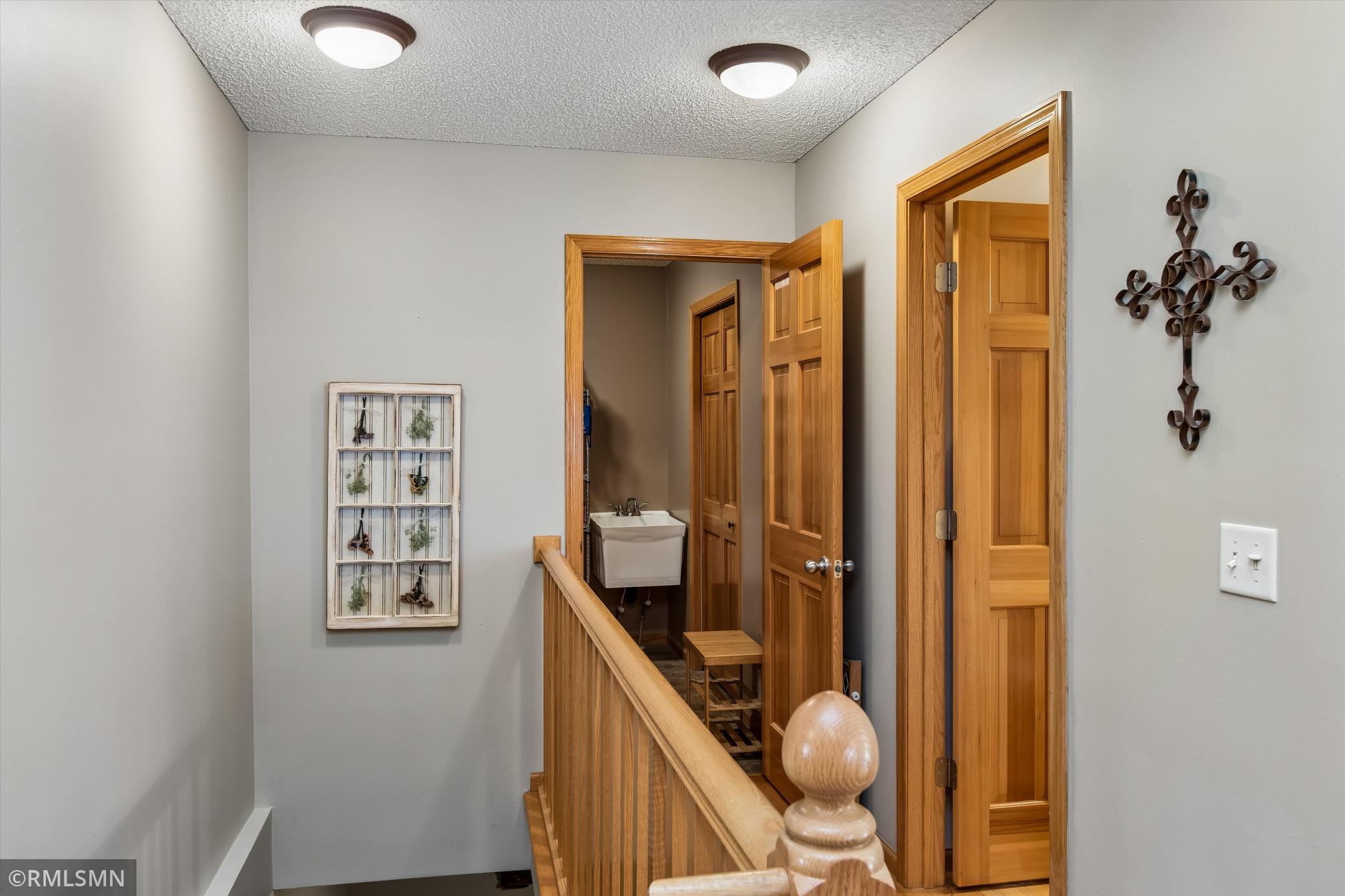 Hallway to main floor half bath and back entryway