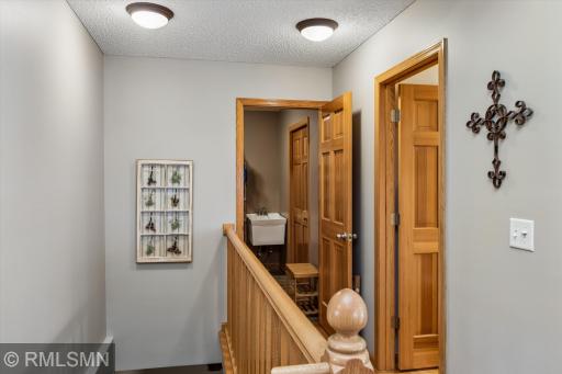 Hallway to main floor half bath and back entryway