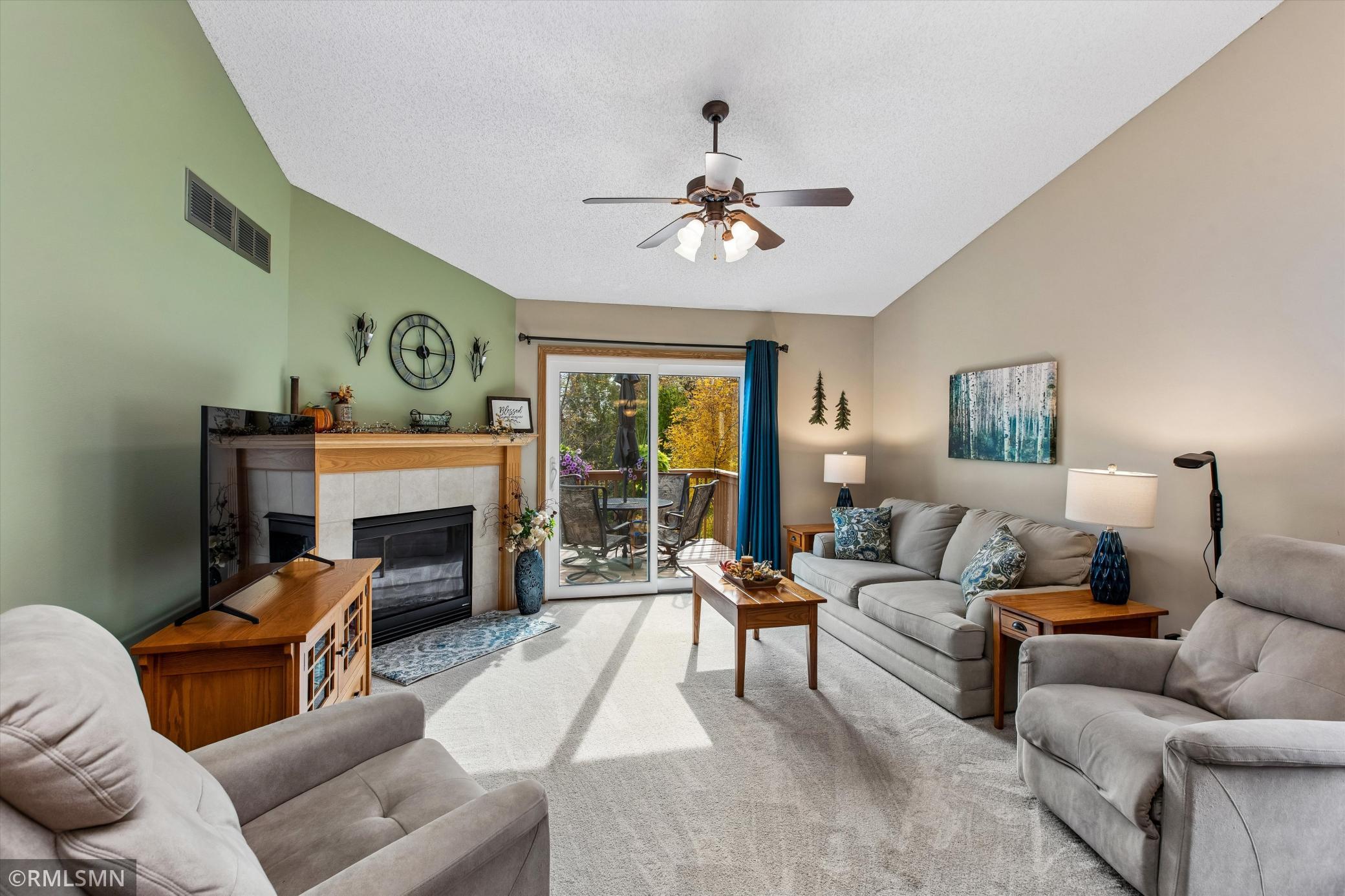Living room with gas fireplace and patio door to the backyard deck