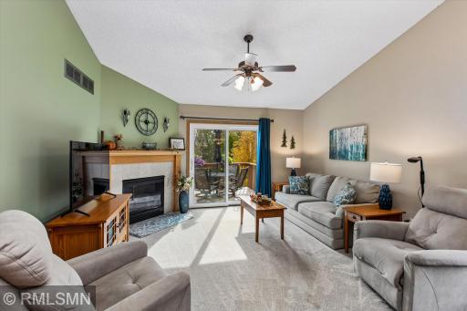 Living room with gas fireplace and patio door to the backyard deck