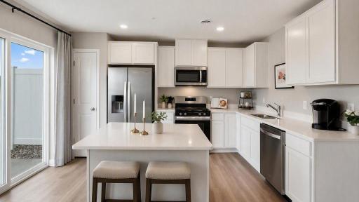This Finley features a kitchen island increasing storage and functionality. Photo of model home. Colors and finishes may vary.