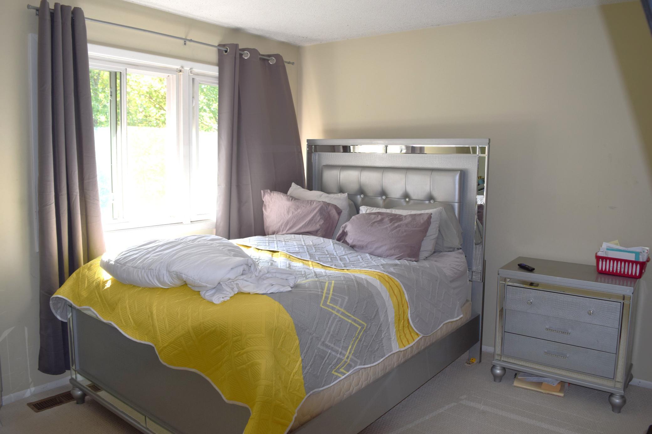 Unit 2 Primary Bedroom that overlooks the backyard.