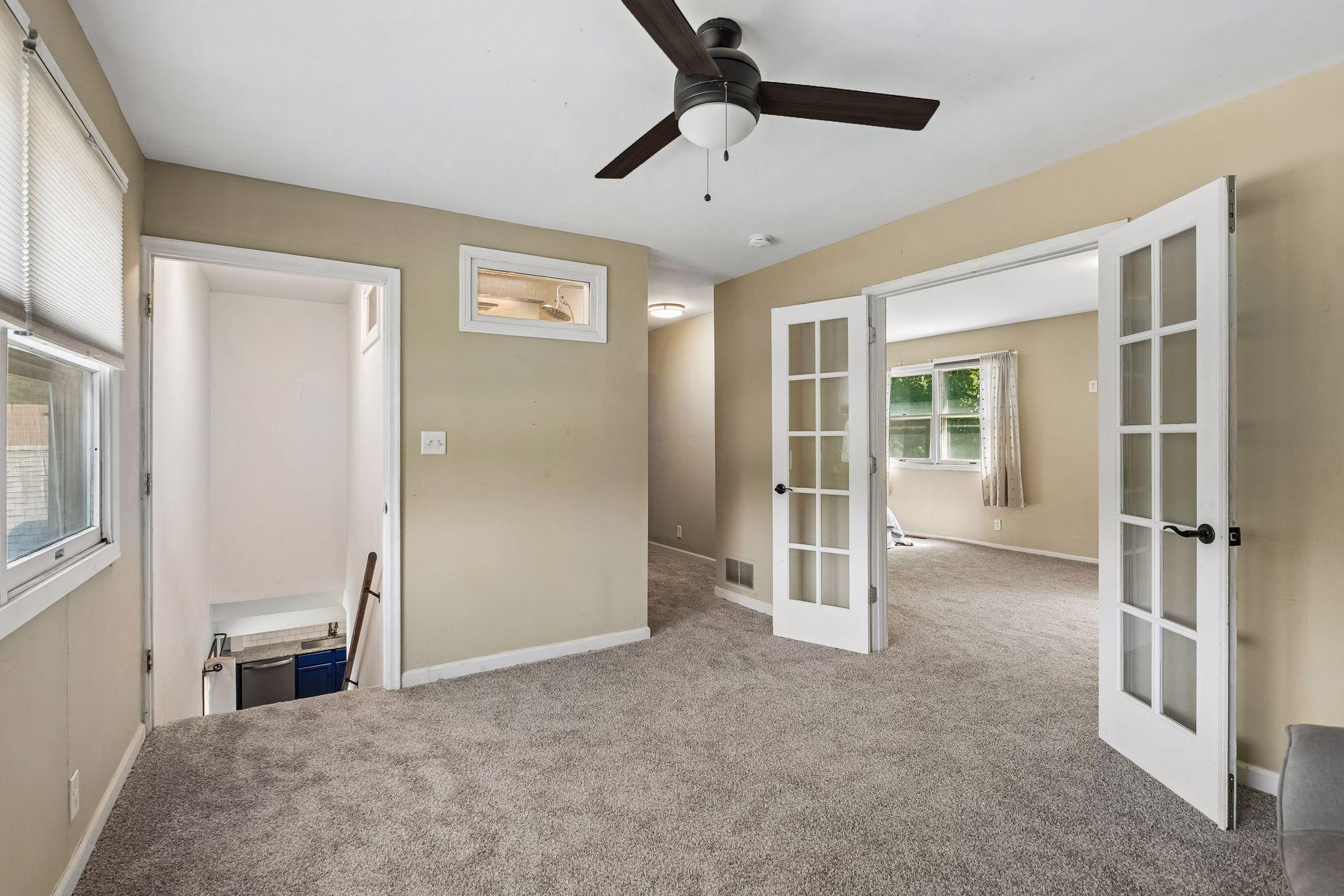 Lovely French doors lead to the primary bedroom.