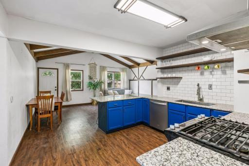 From the front living room you enter into the kitchen that opens onto the large family room.