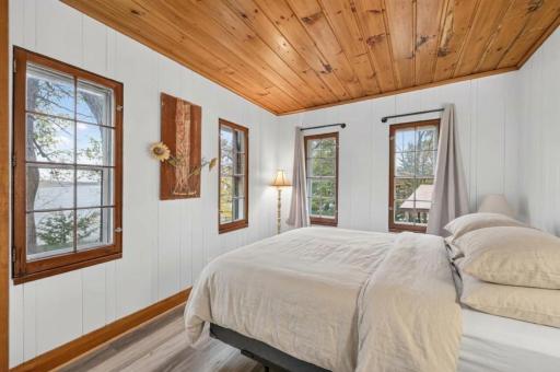 Bedroom #1 with queen sized bed. (Please note: bedding generated using AI.)
