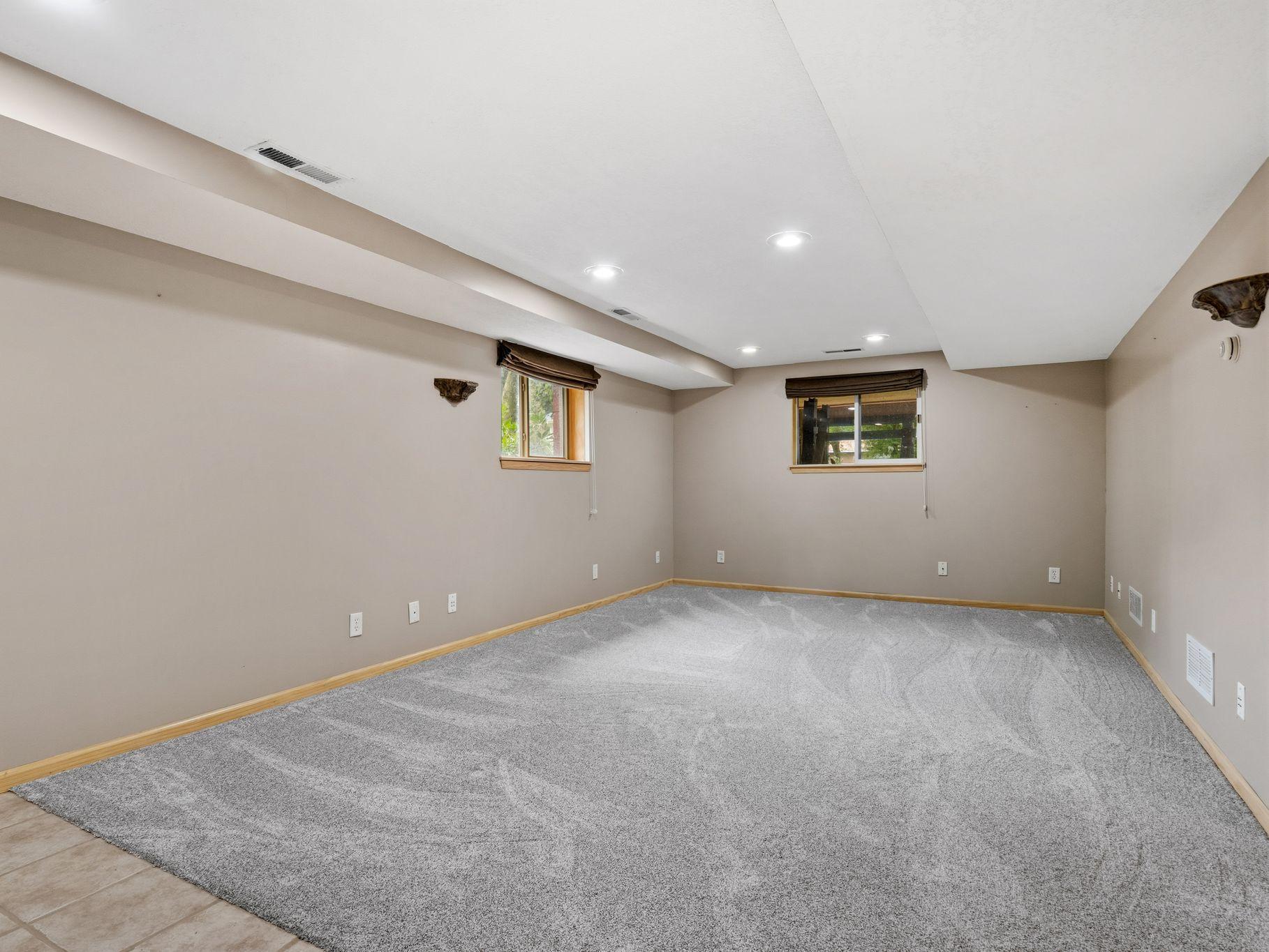 The spacious lower level provides plenty of room to spread out and entertain. With an open layout, comfortable carpeting, recessed lighting, and natural light, this flexible space is ready to become a family room, game room, home theater, or more!