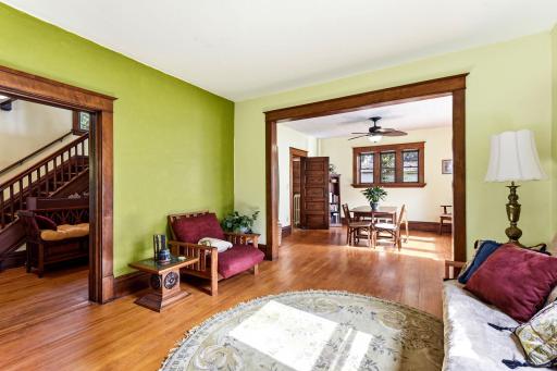 Living & dining room are full of natural light and beautifully preserved woodwork