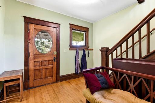 Warm & welcoming foyer features beautifully preserved woodwork