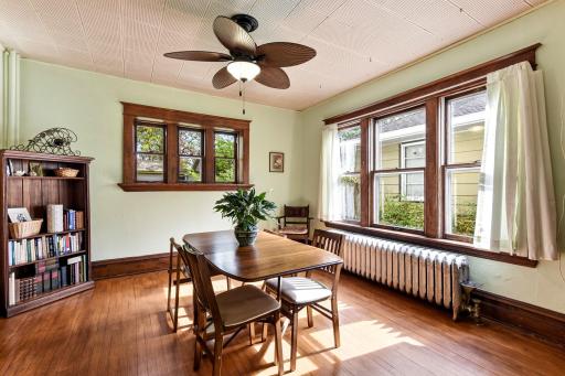 Spacious dining room is full of natural light and beautifully preserved woodwork