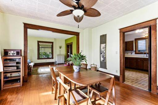 Spacious dining room is full of natural light and beautifully preserved woodwork