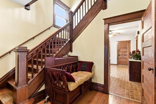 Warm & welcoming foyer features beautifully preserved woodwork