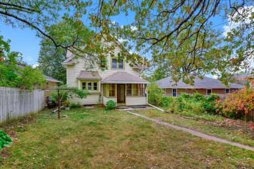 Fully fenced backyard is spacious and pleasant for relaxing, gardening, & more!