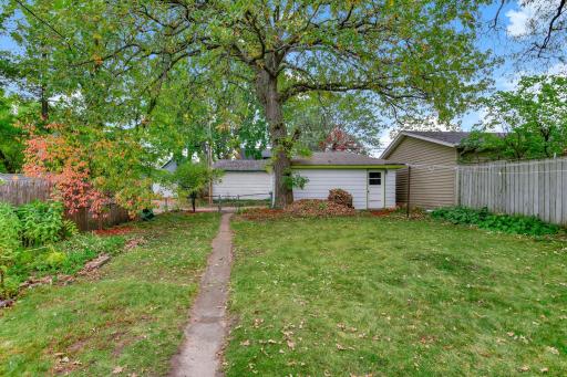 Spacious and fully fenced backyard includes 1 car garage. Garage was built mid-century and has electricity.