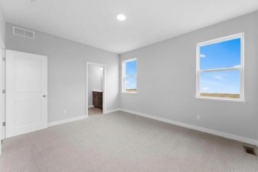 Another view of the primary suite. Photo of actual home.