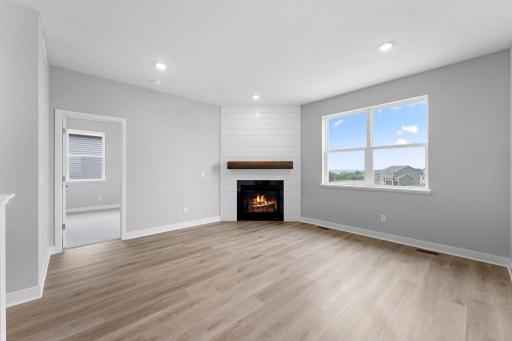 Living room with cozy gas fireplace and panoramic bluff views. Photo of actual home.