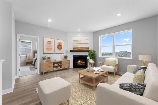 Living room with cozy gas fireplace and panoramic bluff views. Photo of actual home.