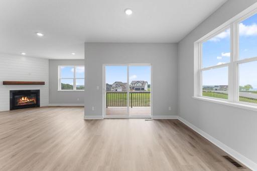 Spacious and sunny dining space leading to the covered deck with panoramic views. Photo of actual home.