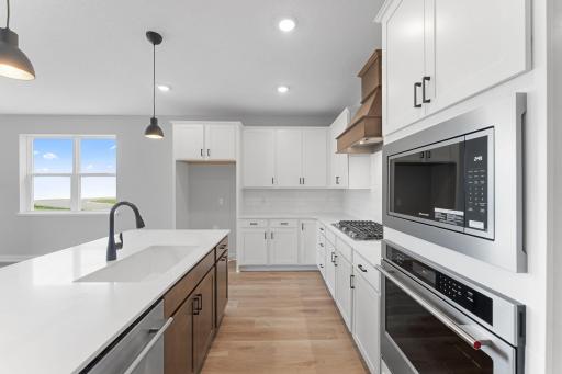 This well thought out kitchen design boasts plenty of cabinet storage and counter space. Photo of actual home.