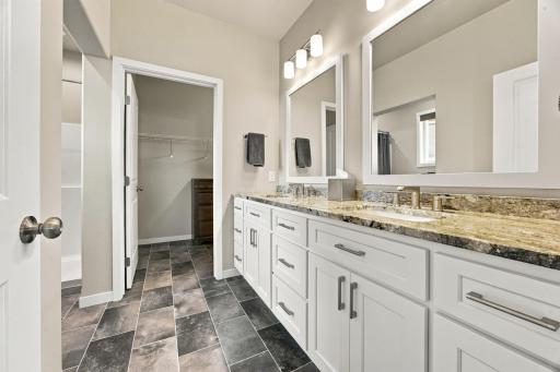 Primary Bathroom with double vanity, walk-in closet and laundry