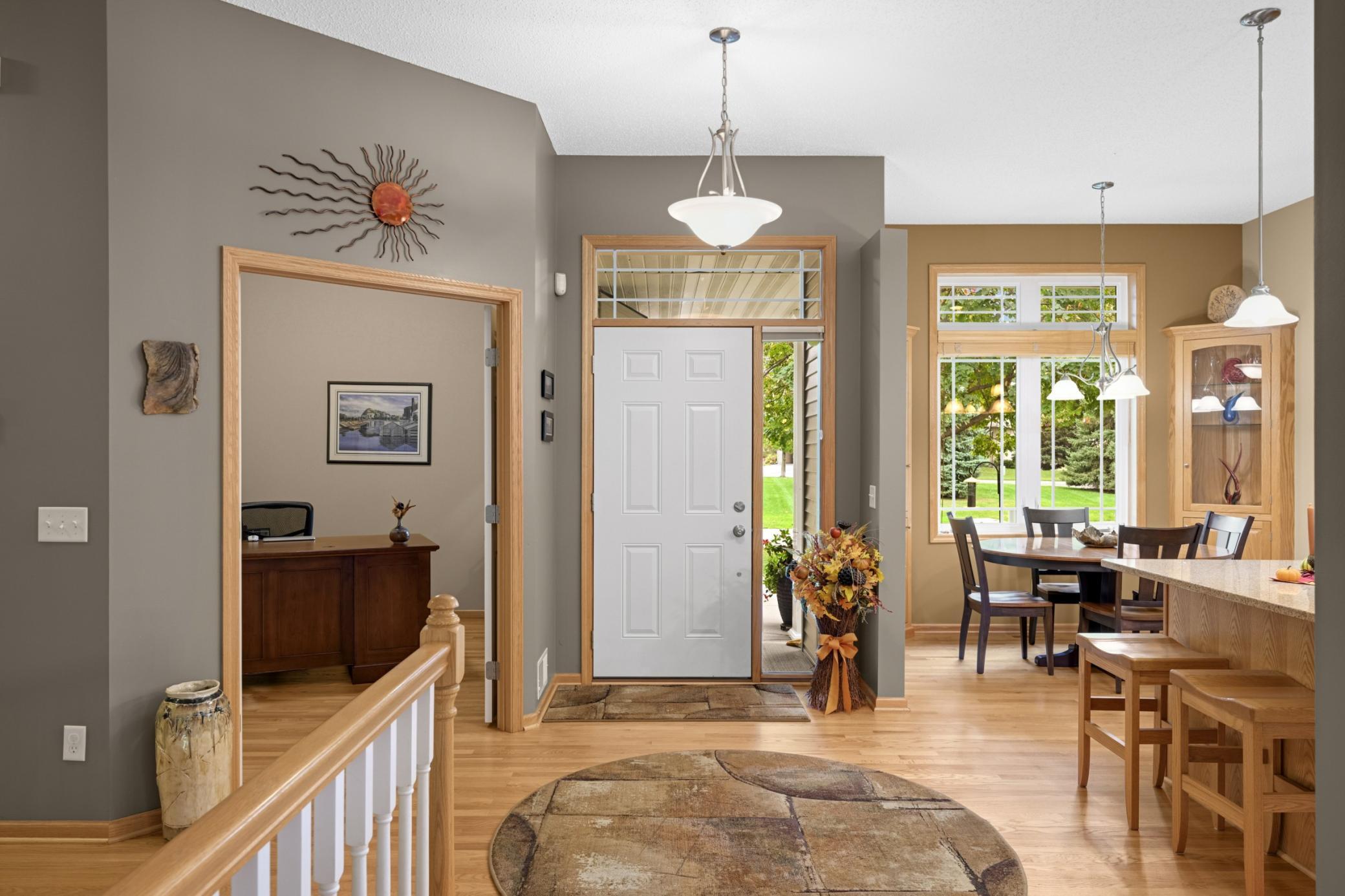 Spacious Foyer with beautiful real hardwood flooring, 10-foot ceilings and transom windows that bring in natural light. The French doors to the main-level Office/Bedroom are just off the entrance.