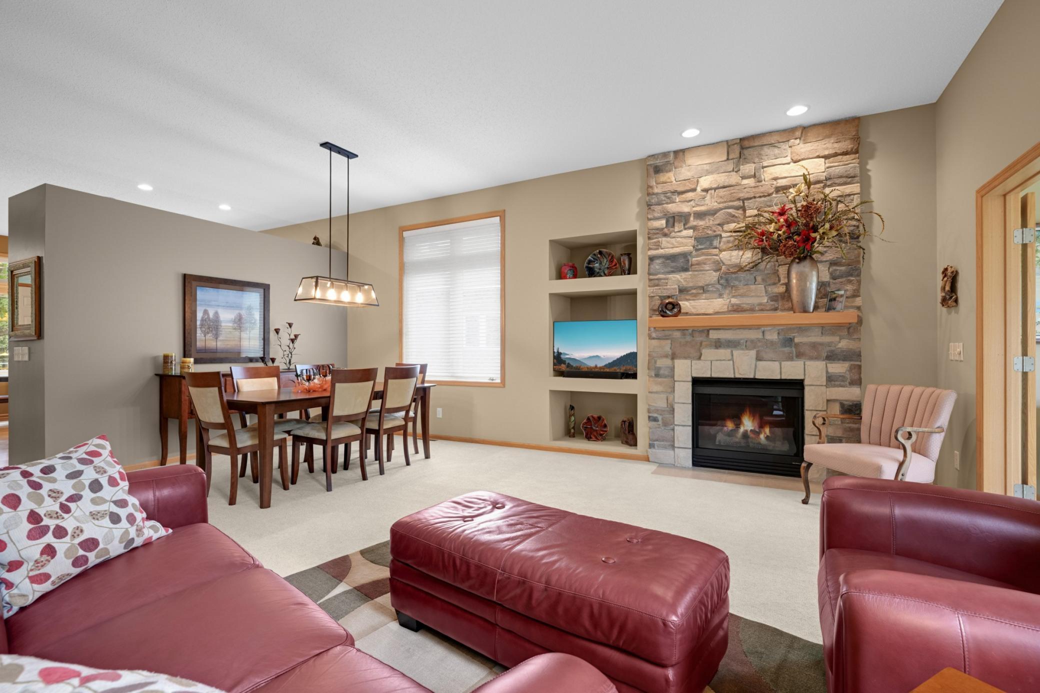 Beautiful stone Gas Fireplace extends to the ceiling and creates a wonderful focal point! The open layout offers plenty of space for both everyday living and entertaining, with built-in display shelves and a spacious Dining Room.
