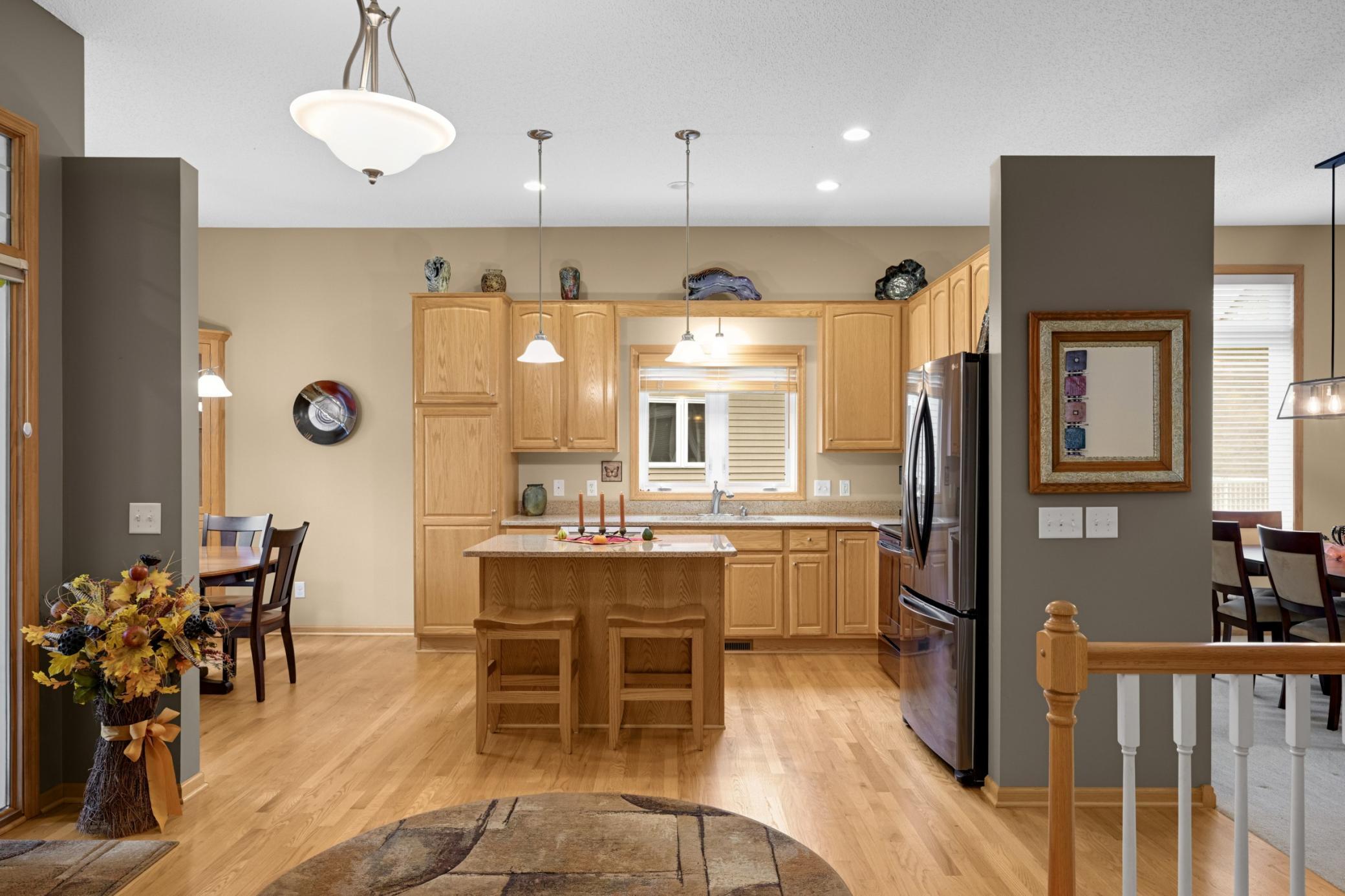 The Kitchen is centrally located with a convenient island for casual dining, granite countertops, stainless steel appliances and beautiful hardwood flooring.