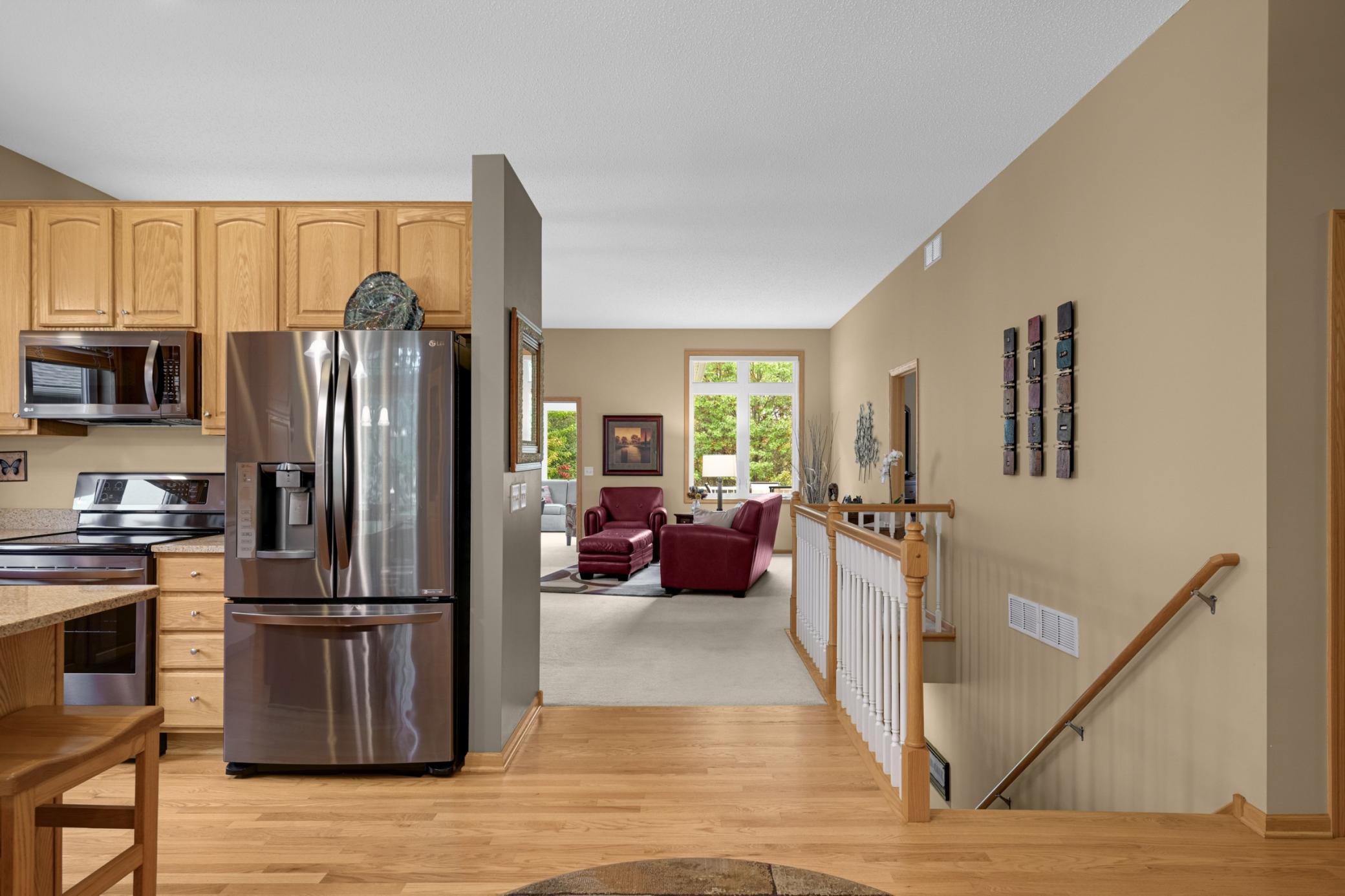 Open layout with hardwood flooring connecting the Kitchen, Dinette and hallway. The Great Room is just beyond, making it easy to stay connected with guests while preparing meals.