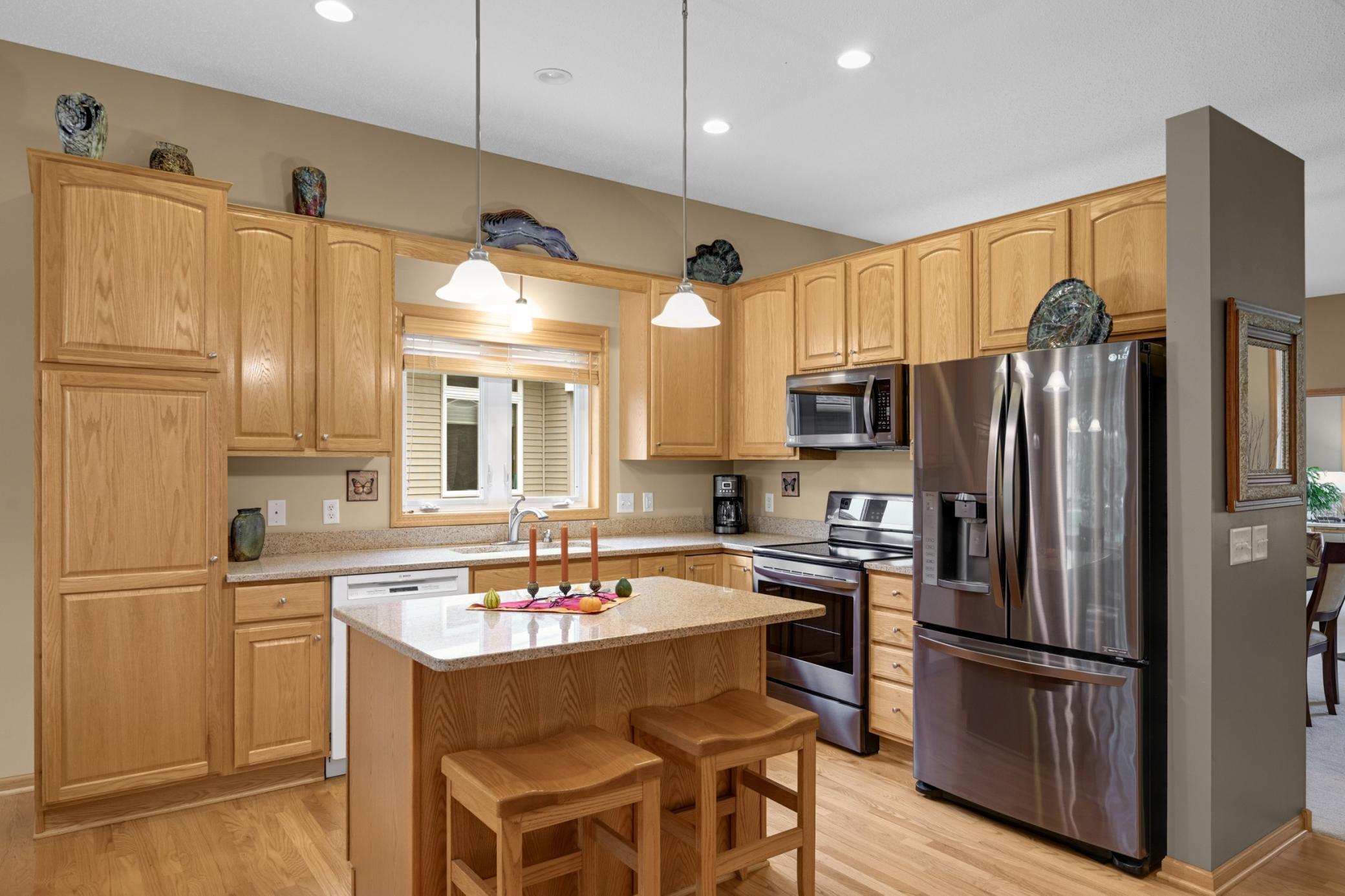 Great Kitchen layout with cabinets extending to the ceiling, plenty of counter space and an island that provides additional workspace and seating. Perfect for everyday cooking or entertaining!