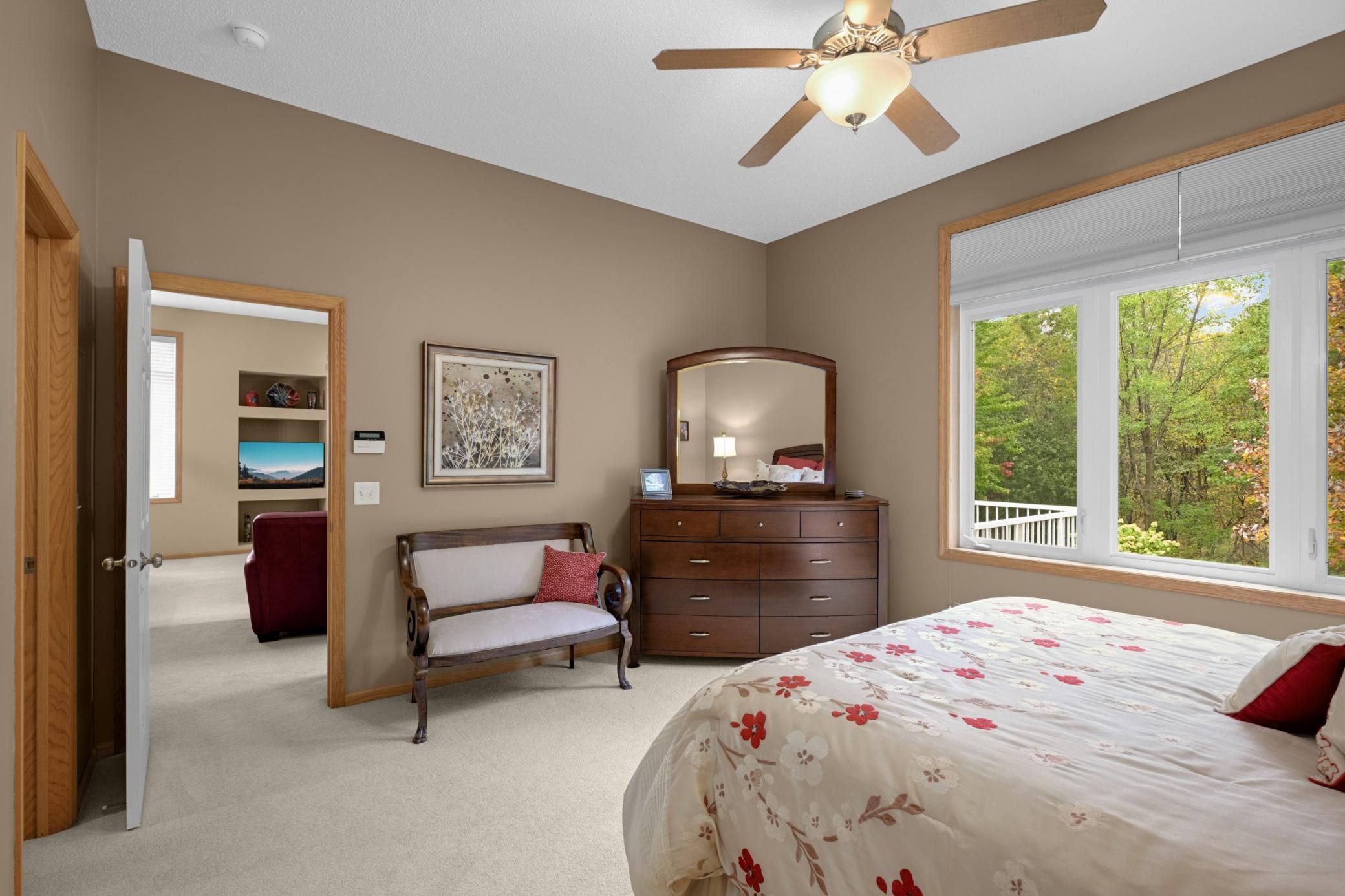 Another view of the Owner's Suite shows the generous room size and beautiful natural light. Enjoy the peaceful surroundings right outside your bedroom window.