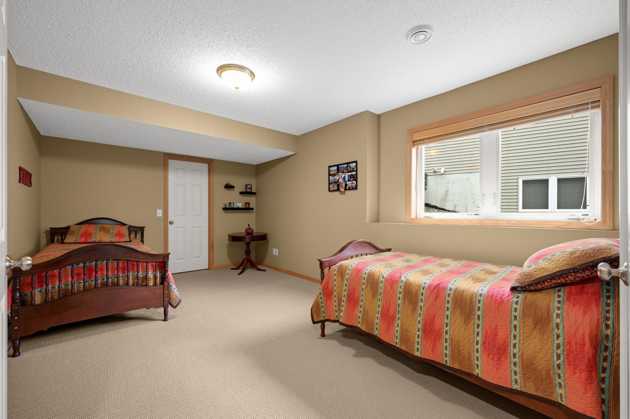 Spacious Lower-Level Bedroom with room for two beds! Perfect for visiting family or guests, giving everyone their own space while staying connected.