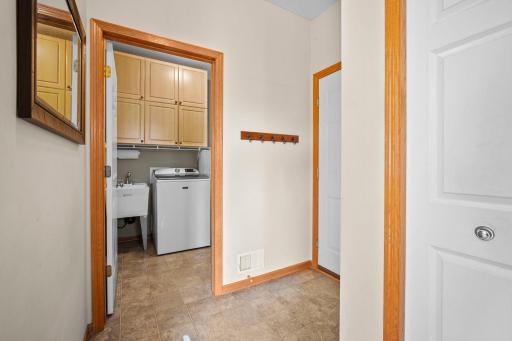 The main level also includes a laundry room with built-in cabinets for ample storage, as well as a half bath.