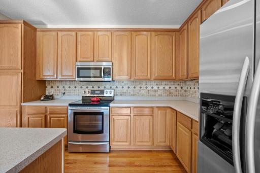 The kitchen is equipped with stainless steel appliances, including a double oven, along with plenty of counter space and cabinetry.
