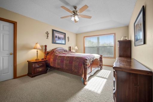 The spacious primary bedroom features a walk-in closet and a private full bathroom with a double-sink vanity, jetted tub, and separate shower.