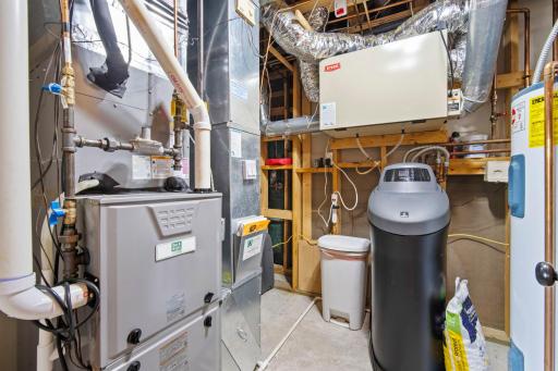 The lower-level utility area includes a newer furnace and air-conditioning system, water heater, and water softener.