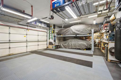 The fully finished three-car garage is insulated and heated for year-round use, with abundant storage space. Please note that the car lift is not included in the sale.