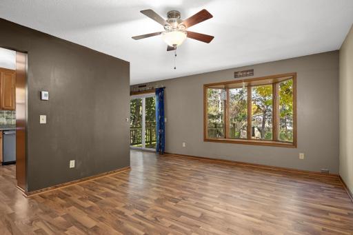 Bright upper-level living room with a large window and easy-care flooring.
