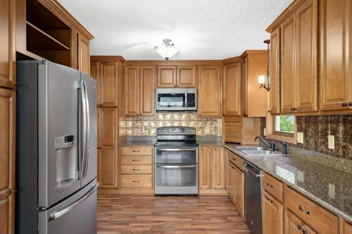 Kitchen features a double oven range, built-in microwave and plentiful storage.
