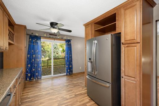 Dining area offers direct deck access and natural light through sliding glass doors.