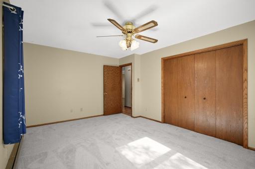 Additional view of the upper-level bedroom highlighting its closet and floor space.