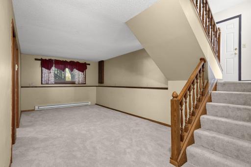 Lower-level family room offers flexible space for relaxing or entertaining