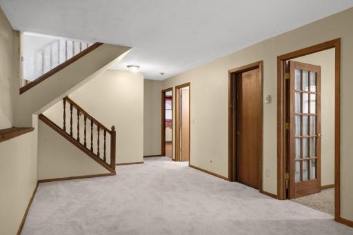 Lower-level hallway connects the living area to additional rooms.