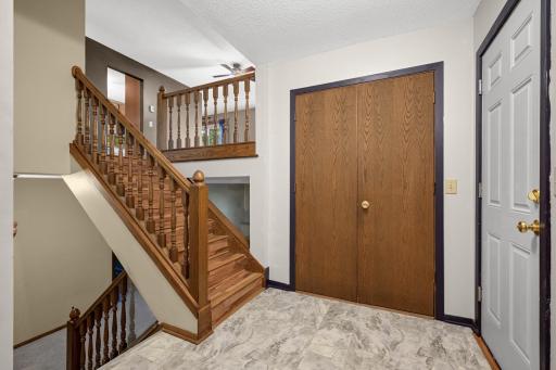 Spacious split-entry foyer with convenient closet storage.