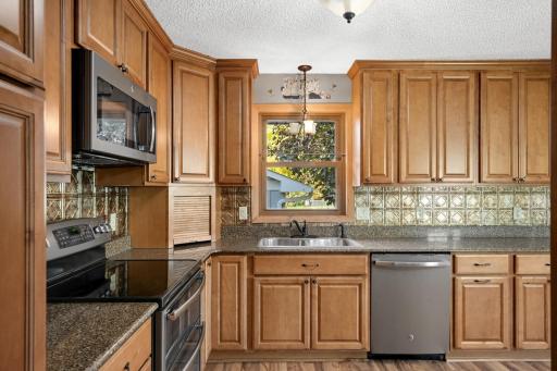 A double-basin sink sits beneath a Extensive countertop workspace.