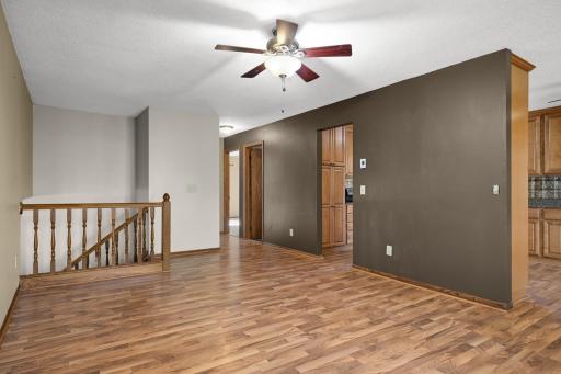 Open flow from the living room toward the kitchen and upper-level bedrooms.