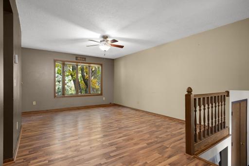 Another view of the upper-level living room with ample space for seating.