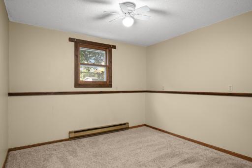 Additional bedroom with neutral finishes and natural light.