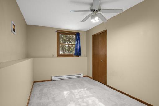 Comfortable bedroom with closet and ceiling fan.