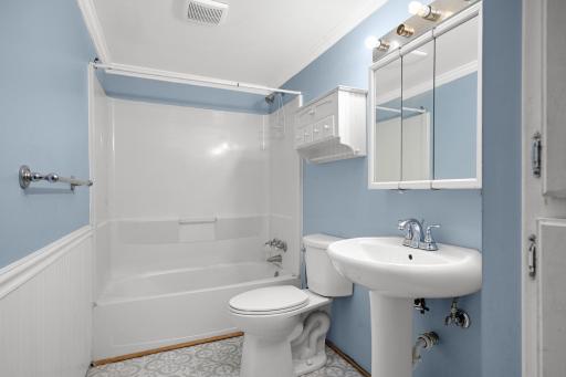 Full bathroom featuring tub/shower combination and pedestal sink.