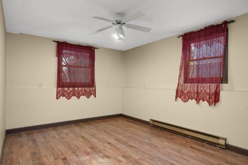 Spacious office with two windows and easy-care flooring.