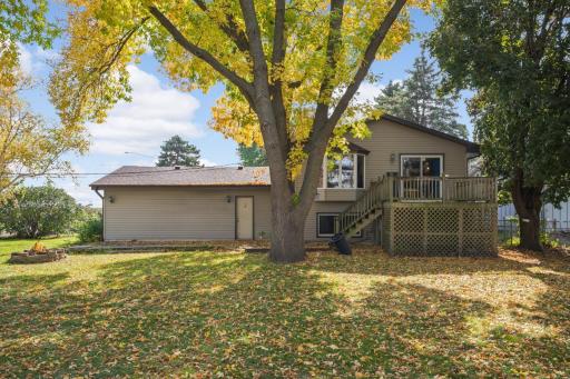 Rear exterior showcasing the elevated deck and expansive backyard.